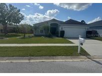 One-story house with attached garage, neat lawn, and a mailbox at 4611 Horseshoe Pick Ln, Valrico, FL 33594