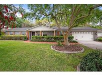 Charming ranch home with mature landscaping and a spacious lawn at 1003 Mandalay Dr, Brandon, FL 33511