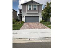 Two-story home with a gray exterior and two-car garage at 11539 Gallatin Trl, Parrish, FL 34219