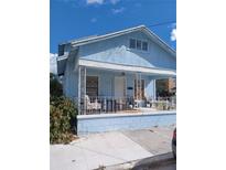 Light blue house with front porch and small yard at 1905 And 1907 N Armenia Ave, Tampa, FL 33607