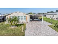 Single-story home with a paved driveway and palm tree landscaping at 37635 Gill Ave, Zephyrhills, FL 33541