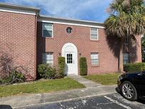 Brick building exterior with white door and landscaping at 1125 83Rd N Ave # A, St Petersburg, FL 33702