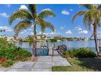 Private dock with walkway leading to the water at 16434 Redington Dr, Redington Beach, FL 33708
