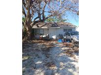 Single-story house with a gravel driveway and mature tree in the front yard at 321 77Th Ave, St Pete Beach, FL 33706