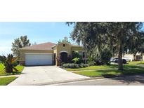 Single-story house with a two-car garage and a landscaped front yard at 107 Slipper Key Rd, Apollo Beach, FL 33572