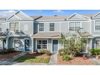 Exterior view of a charming two-story townhouse with well-maintained landscaping at 2248 Lake Woodberry Cir, Brandon, FL 33510