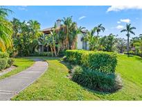 Exterior view of condo with landscaped grounds and walkway at 10263 Gandy N Blvd # 107, St Petersburg, FL 33702