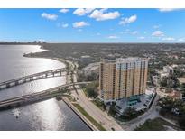 Stunning aerial view of a high-rise condo building with waterfront access and a bridge nearby at 345 Bayshore Blvd # 308, Tampa, FL 33606