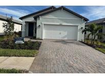 Curb appeal abounds with this charming house featuring a 2-car garage and landscaped yard at 5894 Talon Preserve Ct, Nokomis, FL 34275