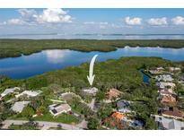 Breathtaking aerial view of a beautiful waterfront home surrounded by lush greenery and serene waters at 7255 18Th Ne St, St Petersburg, FL 33702