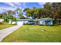 Newly renovated light blue home with a spacious yard at 1042 Idlewild N Dr, Dunedin, FL 34698