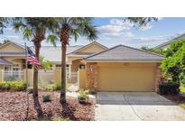 House exterior featuring a tan garage door and stone accents at 13141 Palmilla Cir, Dade City, FL 33525