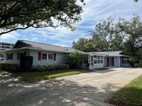 Cute light blue home with a carport and mature landscaping at 1601 Berwick Ct # B, Palm Harbor, FL 34684