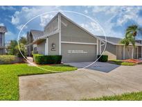 Exterior view of a 3 bed, 2 bath villa with 2-car garage at 3603-B Avenida Madera, Bradenton, FL 34210