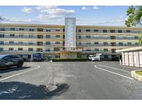 Condo building exterior with parking and landscaping at 8198 Terrace Garden N Dr # 403, St Petersburg, FL 33709