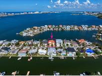 Aerial view of waterfront home with private dock and boat lift at 18 Winston Dr, Belleair, FL 33756