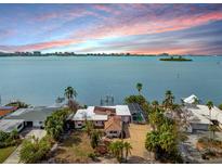 Aerial view of waterfront home with expansive bay views and private dock at 1840 Venetian Point Dr, Clearwater, FL 33755