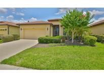 Charming single-story home featuring a well-manicured lawn and a classic tile roof at 5721 Sunset Falls Dr, Apollo Beach, FL 33572