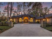 Elegant home with a circular driveway and landscaped yard at 6515 Stonington S Dr, Tampa, FL 33647