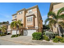 Beautiful 3 story tan townhouse with 3 car garage at 562 Rivercrest Ln, Tarpon Springs, FL 34689