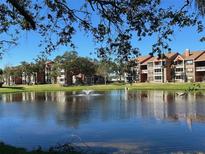 Waterfront community view with pond and fountain, featuring multiple apartment buildings at 10200 Gandy N Blvd # 921, St Petersburg, FL 33702