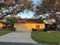 Single story home with attached garage and landscaped yard at 3963 Glen Oaks Manor Dr, Sarasota, FL 34232