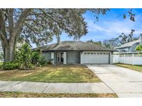 Single-story home with stone facade and garage at 6308 Nesting Ct, Tampa, FL 33625