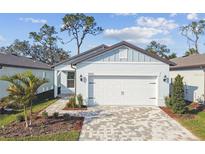 Charming single-Gathering home featuring a two-car garage and well-manicured front yard at 9450 Shorebird Ct, Parrish, FL 34219