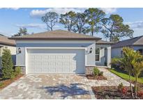 Charming single-Gathering home with a brick driveway and a two-car garage at 9462 Shorebird Ct, Parrish, FL 34219