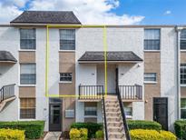 Front view of a two-story condo building with stairs and landscaping at 107 Caldwell Dr # 291, Brandon, FL 33510
