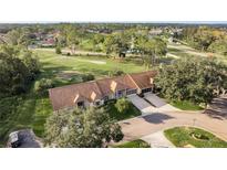 Sprawling single Gathering home featuring a tile roof and long driveway, set in the middle of a scenic golf course community at 5935 Precious View Ct, New Port Richey, FL 34655