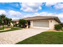 Attractive single-story home with a paved driveway and well-manicured lawn at 1623 Faxton Dr, Sun City Center, FL 33573