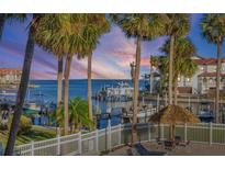 Stunning sunset view over the marina, boats, and palm trees at 363 Pinellas Bayway S # 33, Tierra Verde, FL 33715