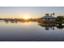 Scenic waterfront view of the community clubhouse and boat docks during a beautiful sunset at 5608 Tidewater Preserve Blvd, Bradenton, FL 34208