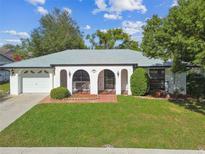 Single story home with a two car garage and well maintained lawn at 6243 Seaford Dr, Holiday, FL 34690