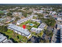An aerial view shows the community's layout, common areas, and a sparkling swimming pool, surrounded by well-maintained landscaping at 716 Oakgrove Dr # 240, Brandon, FL 33510