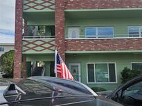 Exterior view of a two story building with green and brown accents at 2359 Finlandia Ln # 27, Clearwater, FL 33763