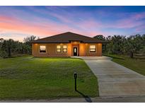 Single-story home with a well-maintained lawn at 397 Doniphan Dr, Port Charlotte, FL 33954