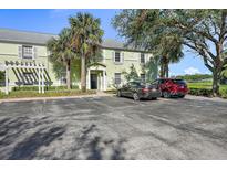 Light green condo building with parking and lush landscaping at 4832 Cobia Se Dr # B, St Petersburg, FL 33705