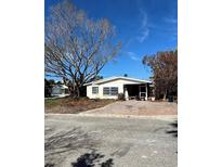 Single-story home with a brick driveway and mature tree at 200 175Th E Ave, Redington Shores, FL 33708