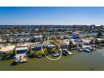 Bird's-eye view of waterfront home with boat dock at 17726 Long Point Dr, Redington Shores, FL 33708
