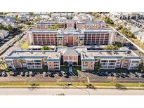Aerial view of a large apartment building with ample parking at 1900 68Th N St # 301, St Petersburg, FL 33710