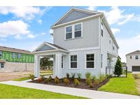 Two-story light gray home with landscaping at 2021 Amelia Bay Pl, Valrico, FL 33596
