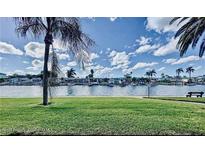 Scenic waterfront view with lush landscaping and canal access at 4660 Marine Pkwy # 202, New Port Richey, FL 34652