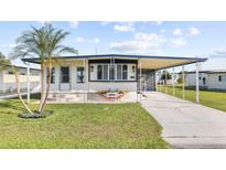 Single-Gathering home with carport and landscaped yard at 35209 Ada Ave, Zephyrhills, FL 33541
