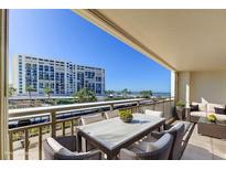 Balcony area features seating, tables, and beach views at 1430 Gulf Blvd # 204, Clearwater Beach, FL 33767