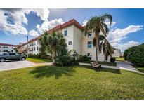 Building exterior showcasing landscaping and parking at 2700 Bayshore Blvd # 4304, Dunedin, FL 34698