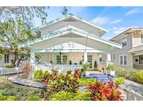 Charming two-story home featuring manicured landscaping, a cozy front porch, and craftsman details at 325 18Th Ne Ave, St Petersburg, FL 33704