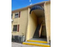 Condo building exterior with stairs and awning at 7639 Dolonita Dr # 7639, Tampa, FL 33615