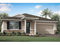 One-story home with a two-car garage, stone accents, and landscaping at 5216 124Th E Ave, Parrish, FL 34219